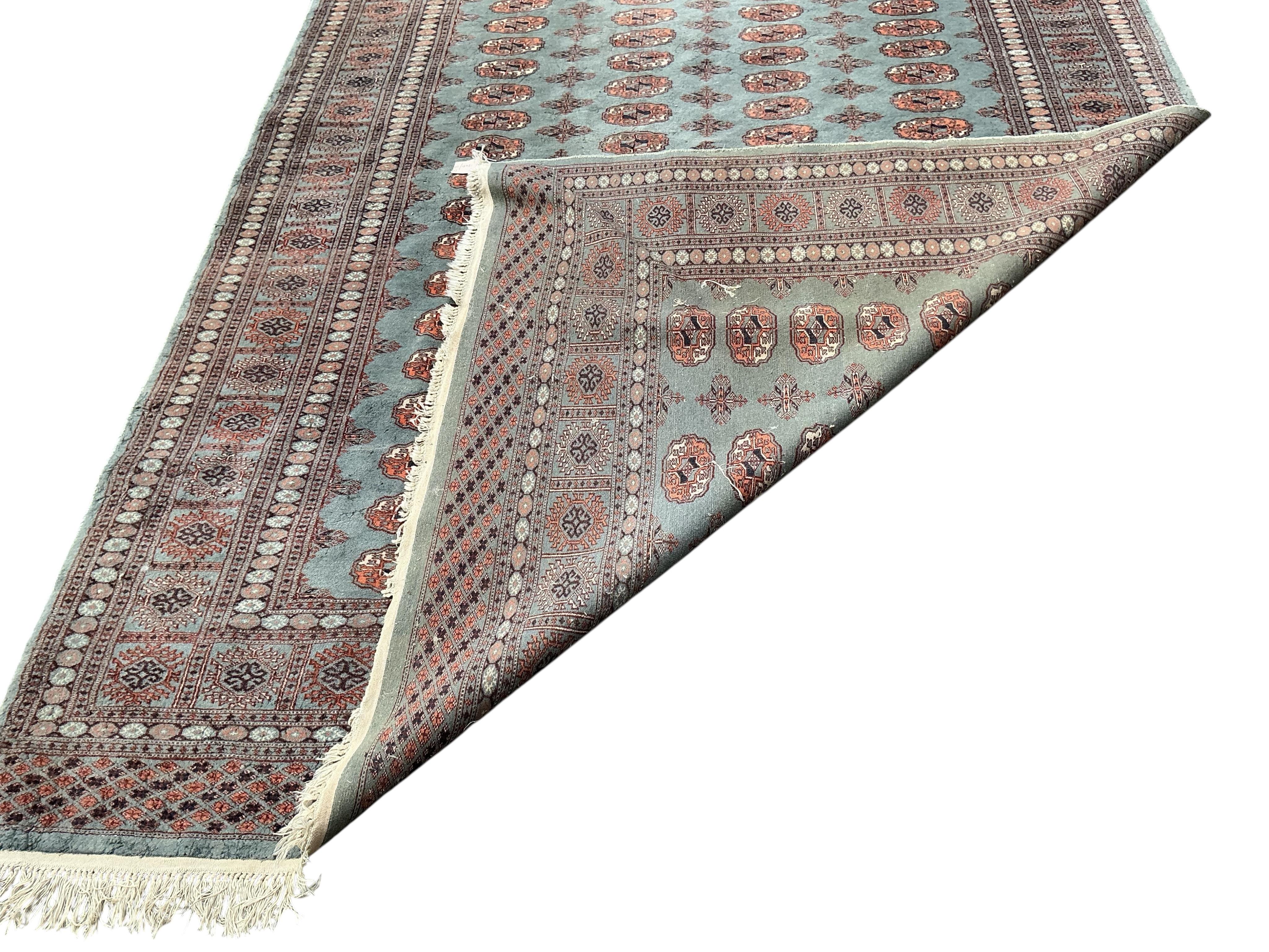 A Bokhara carpet and a smaller Caucasian style rug, larger 290 x 186cm